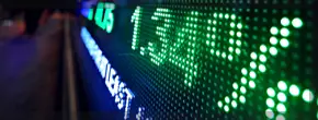 Detailed view of a stock market screen with green indicators, reflecting upward trends in stock prices